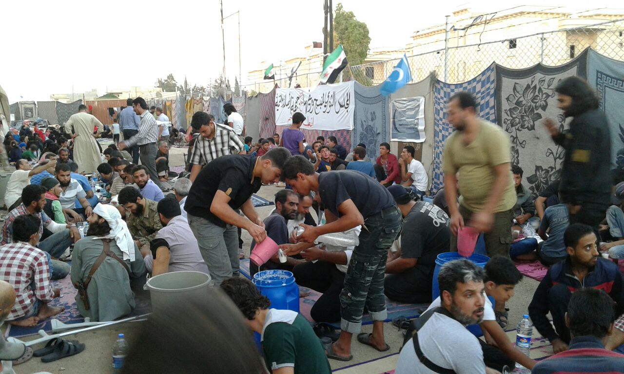 a large group of people sitting on the ground