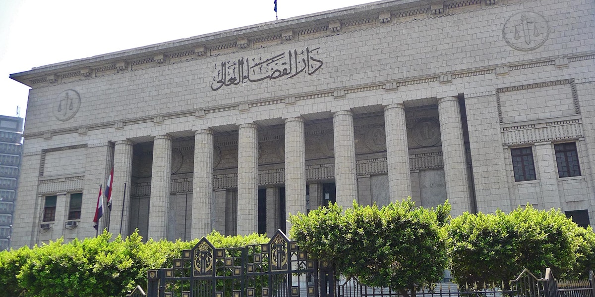a large building with columns and a gate