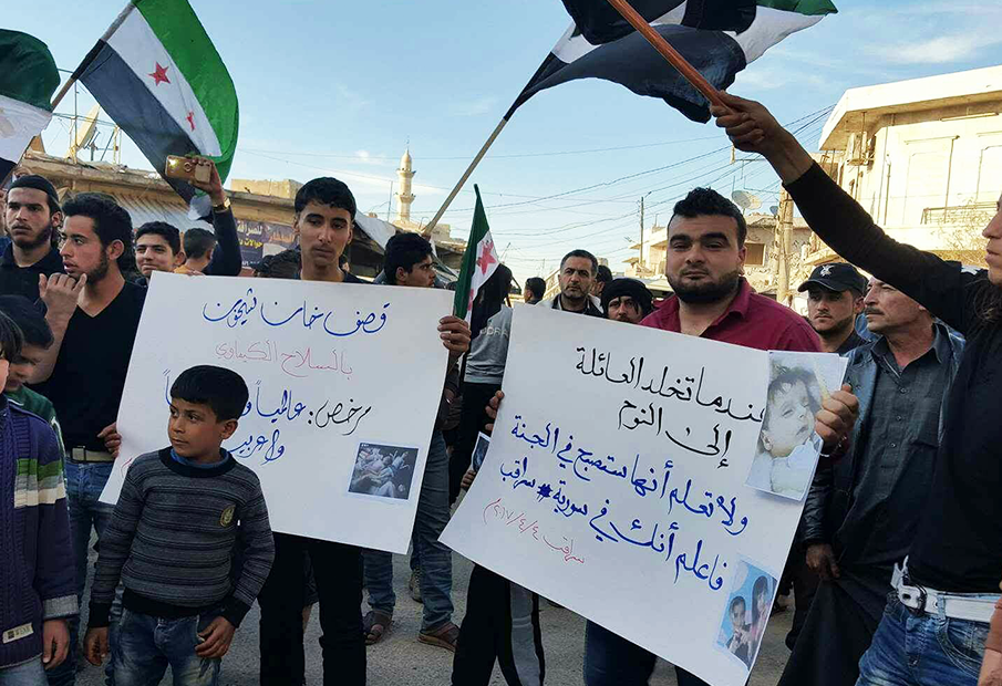 a group of people holding signs and flags