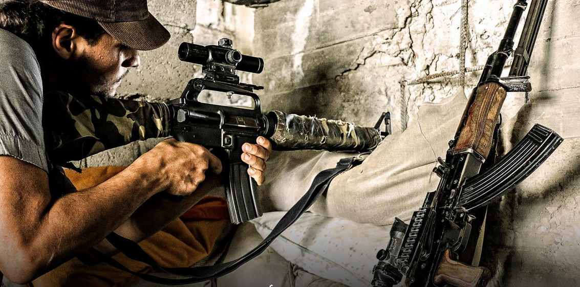 a man with a gun and a rifle