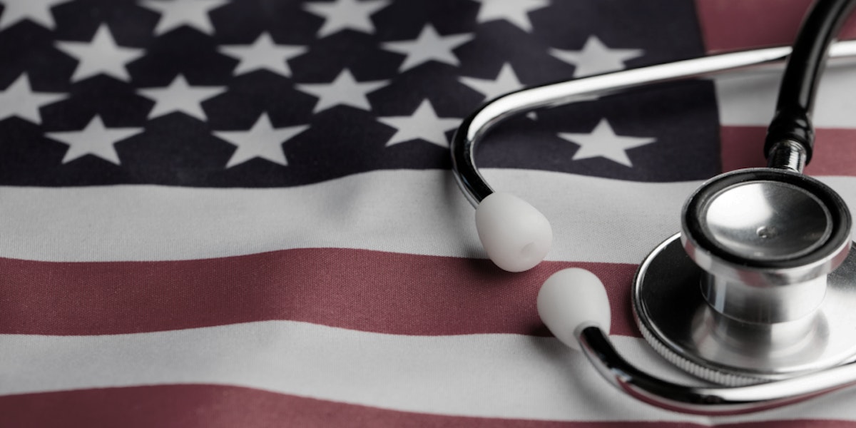 a stethoscope laying on top of an american flag