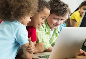 Preschool children looking on a laptop