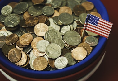 Bowl filled with cash in patriotic colors. Charity and donation theme