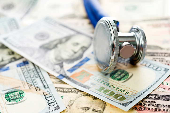 Stethoscope over the dollar bills.