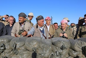 Masoud Barzani and other men dressed in military uniform