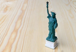 American symbol - Statue of Liberty. New York, USA on wooden table with background.American symbol - Statue of Liberty. New York, USA on wooden table with background.