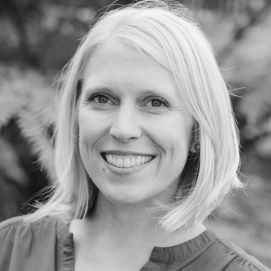a black and white photo of a woman smiling