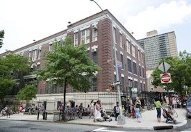 New York City, USA - June 17, 2013: Large school building in Brooklyn at the corner of Hicks Street and Middagh Street. Parents and nanny's pick up the kids after school.