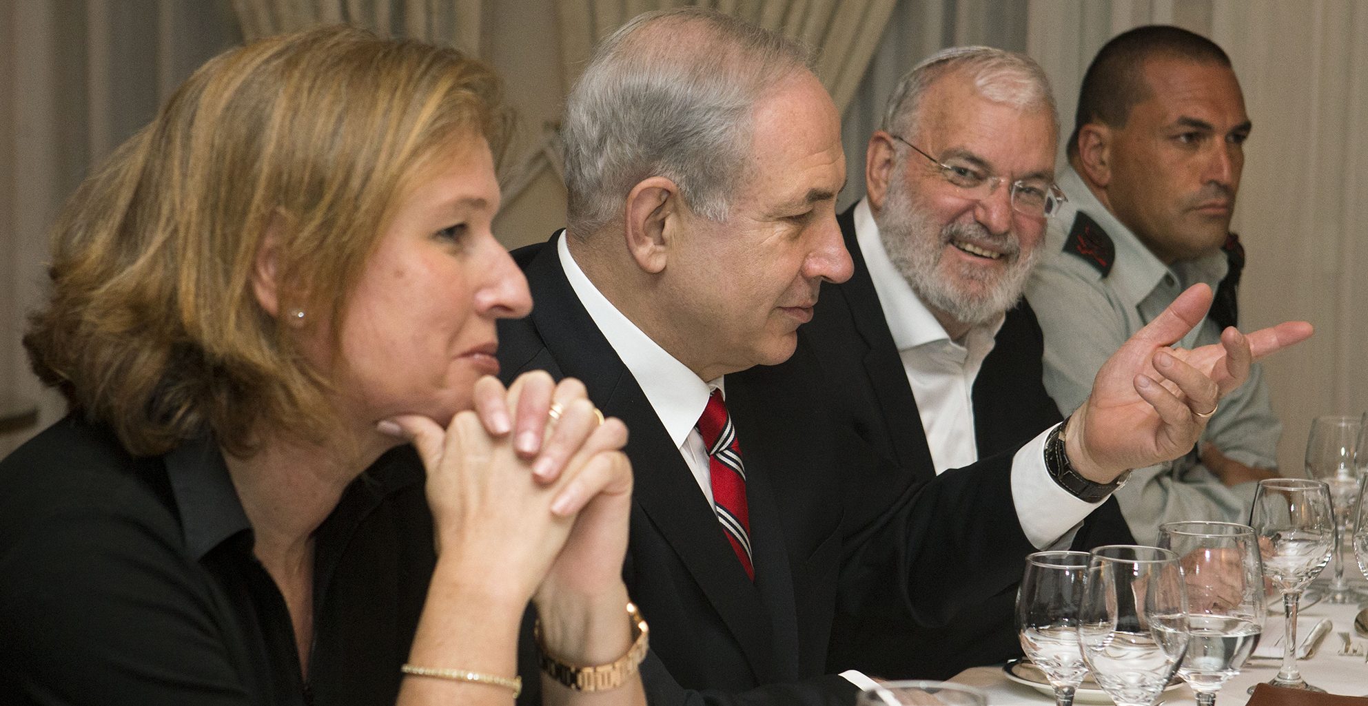 Tzipi Livni, Israel's chief negotiator with the Palestinians (L) sits next to Israel's Prime Minister Benjamin Netanyahu, with Yaakov Amidror, National Security Advisor to the Prime Minister, and Military Secretary Major General Eyal Zamir, as Netanyahu meets with U.S. Secretary of State John Kerry (unseen) in Jerusalem on June 29, 2013. Kerry kept up his frenetic Mideast diplomacy shuttling again between Palestinian and Israeli leaders in hopes of restarting peace talks.AFP PHOTO/JACQUELYN MARTIN-POOL        (Photo credit should read JACQUELYN MARTIN/AFP/Getty Images)