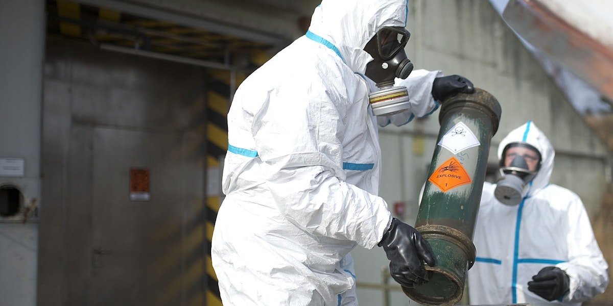 MUNSTER, GERMANY - MARCH 05: Workers in protective clothing unload a dummy grenade during a press day at the GEKA facility on March 5, 2014 in Munster, Germany. GEKA is federally-funded and its sole function is the destruction of chemical weapons from military arsenals. Syria agreed to give up its chemical weapons last August and disposal, which is already underway on an American ship in the Mediterranean, is scheduled to be completed by June. (Photo by Nigel Treblin/Getty Images)