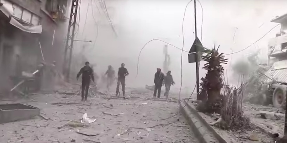 People walking through dust and rubble