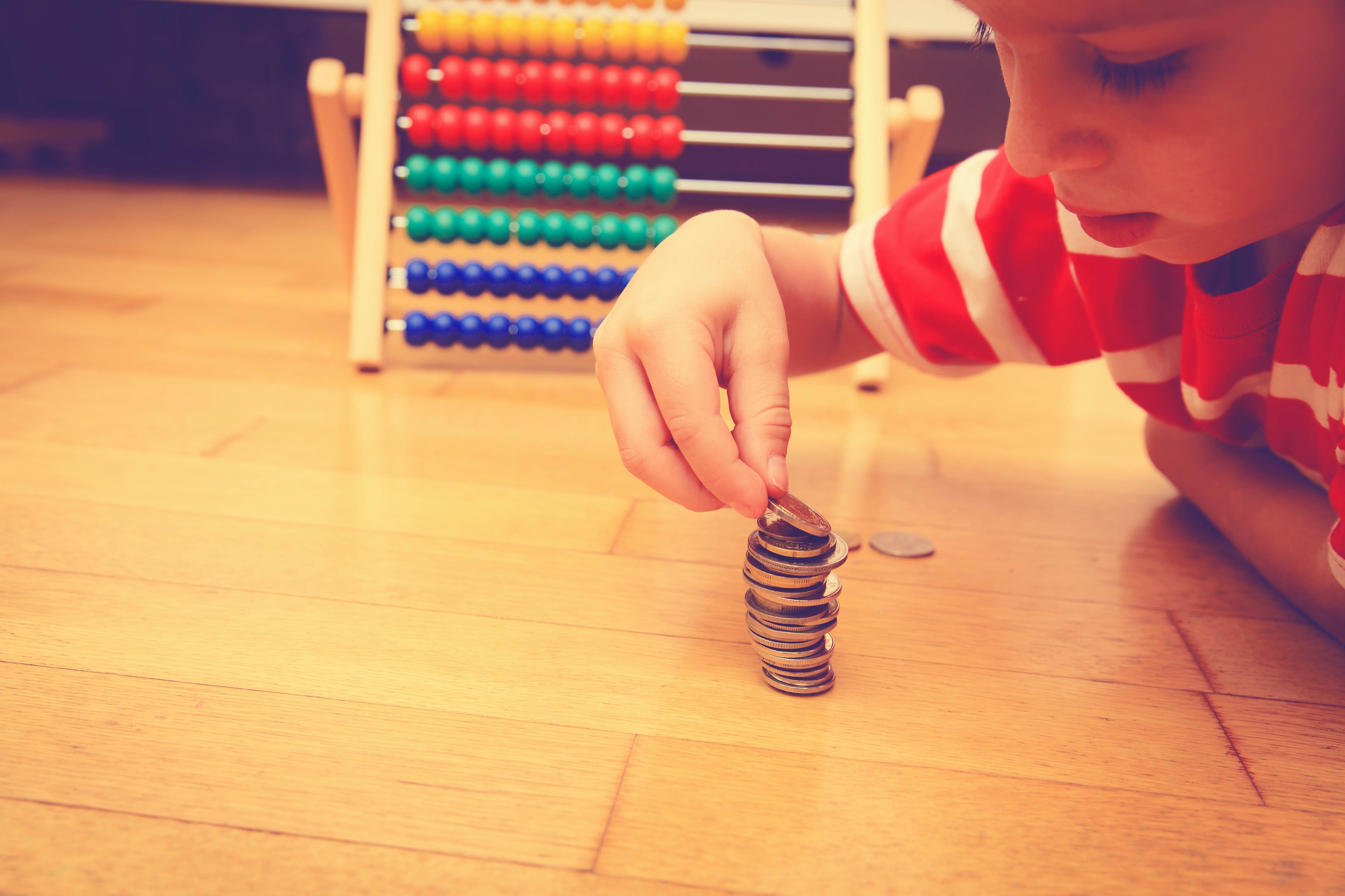 Little boy counting his savings, saving and learning money