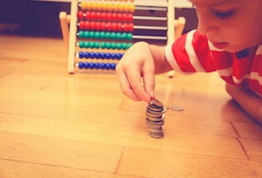 Little boy counting his savings, saving and learning money