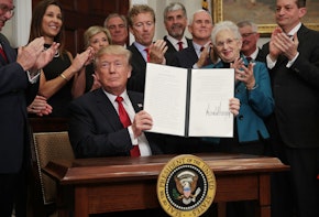 WASHINGTON, DC - OCTOBER 12:  U.S. President Donald Trump shows an executive order after he signed it as Sen. Rand Paul (R-KY), Vice President Mike Pence, Rep. Virginia Foxx (R-NC) and Secretary of Labor Alexander Acosta look on during an event in the Roosevelt Room of the White House October 12, 2017 in Washington, DC. President Trump signed the executive order to loosen restrictions on Affordable Care Act 