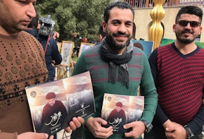 Majid Hamid and his companions distribute glossy fliers with Moqtada al-Sadr’s most recent pronouncements at the Baghdad Cultural Center