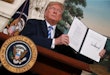 WASHINGTON, DC - MAY 08: U.S. President Donald Trump holds up a memorandum that reinstates sanctions on Iran after he announced his decision to withdraw the United States from the 2015 Iran nuclear deal in the Diplomatic Room at the White House May 8, 2018 in Washington, DC. After two and a half years of negotiations, Iran agreed in 2015 to end its nuclear program in exchange for Western countries, including the United States, lifting decades of economic sanctions. Since then international inspectors have not found any violations of the terms by Iran. (Photo by Chip Somodevilla/Getty Images)