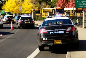 Roseburg Oregon - October 16, 2012: Police cars and school buses at an accident scene at the entrance of the High School loading zone