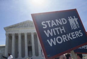 WASHINGTON, DC - JUNE 25: A demonstrator holds a sign in front of the U.S. Supreme Court on June 25, 2018 in Washington, DC. The high court is expected to issue decisions in six remaining cases, including the travel ban, public sector unions and redistricting, ahead of their end-of-June deadline this week.  (Photo by Zach Gibson/Getty Images)