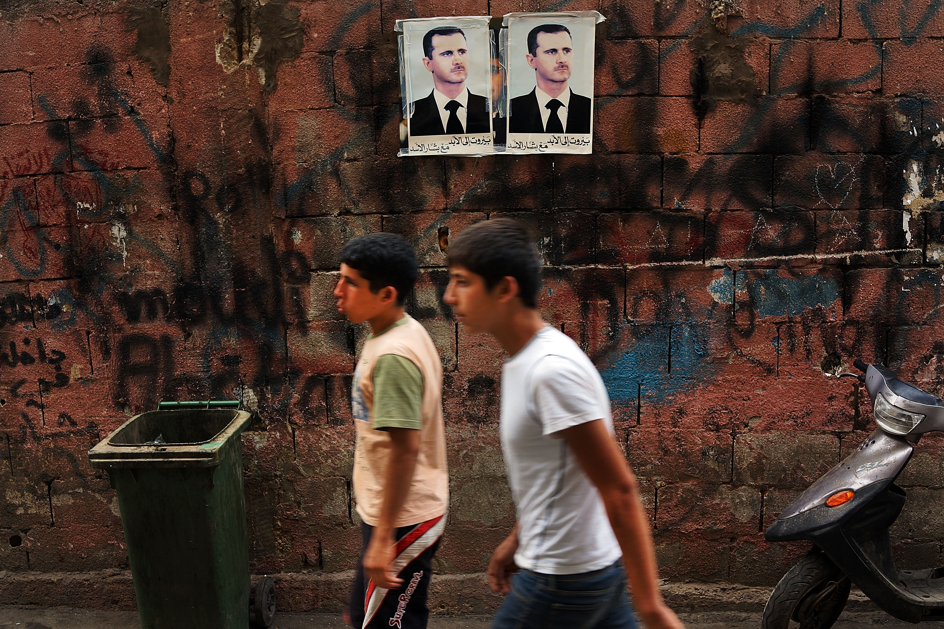 BEIRUT, LEBANON - JUNE 30: Pictures of Syrian president Bashar al-Assad are viewed along a wall in a poor, Hezbollah influenced neighborhood with a high concentration of Syrian refugees on June 30, 2013 in Beirut, Lebanon. Currently the Lebanese government officially hosts 546,000 Syrians with an estimated additional 500,000 who have not registered with the United Nations. Lebanon, a country of only 4 million people, is now home to the largest number of Syrian refugees who have fled the conflict. The situation is beginning to put a huge social and political strains on Lebanon as there is currently no end in sight to the war in Syria. (Photo by Spencer Platt/Getty Images)