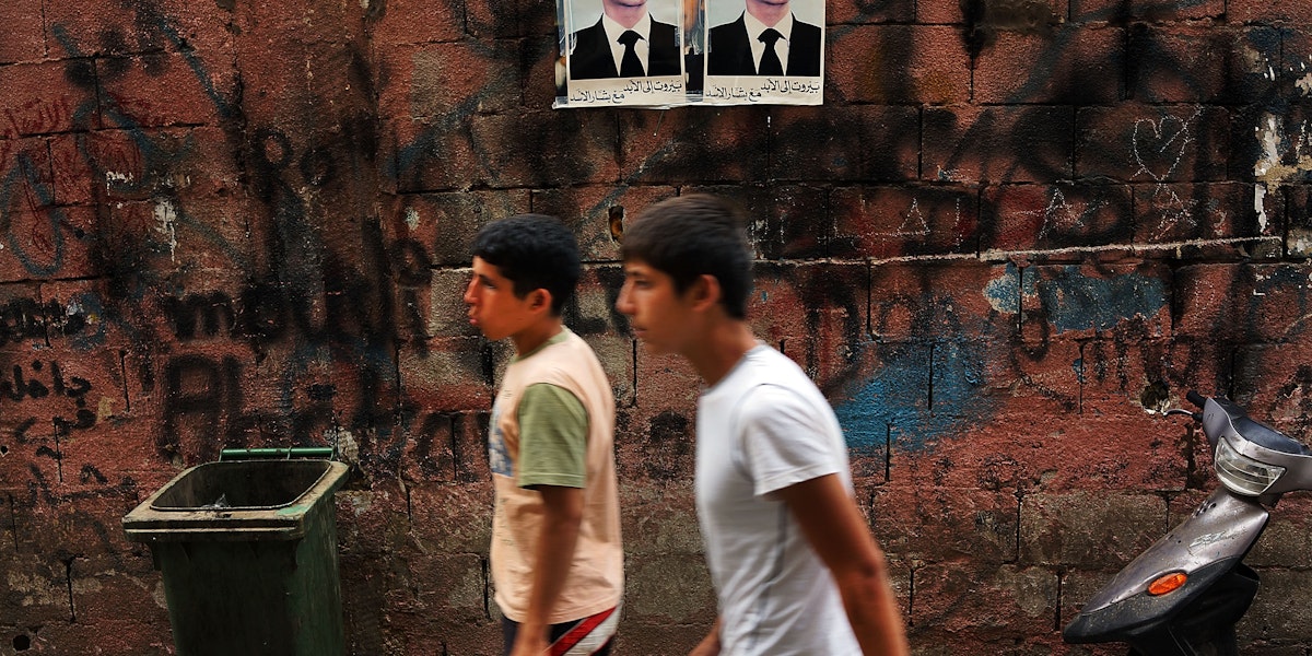 BEIRUT, LEBANON - JUNE 30: Pictures of Syrian president Bashar al-Assad are viewed along a wall in a poor, Hezbollah influenced neighborhood with a high concentration of Syrian refugees on June 30, 2013 in Beirut, Lebanon. Currently the Lebanese government officially hosts 546,000 Syrians with an estimated additional 500,000 who have not registered with the United Nations. Lebanon, a country of only 4 million people, is now home to the largest number of Syrian refugees who have fled the conflict. The situation is beginning to put a huge social and political strains on Lebanon as there is currently no end in sight to the war in Syria. (Photo by Spencer Platt/Getty Images)