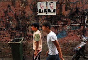 BEIRUT, LEBANON - JUNE 30: Pictures of Syrian president Bashar al-Assad are viewed along a wall in a poor, Hezbollah influenced neighborhood with a high concentration of Syrian refugees on June 30, 2013 in Beirut, Lebanon. Currently the Lebanese government officially hosts 546,000 Syrians with an estimated additional 500,000 who have not registered with the United Nations. Lebanon, a country of only 4 million people, is now home to the largest number of Syrian refugees who have fled the conflict. The situation is beginning to put a huge social and political strains on Lebanon as there is currently no end in sight to the war in Syria. (Photo by Spencer Platt/Getty Images)