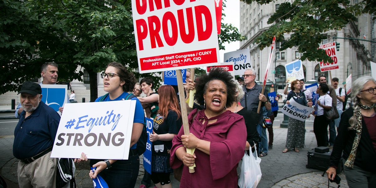 A photograph of a demonstration. Signage about equity and unions