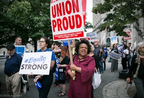 A photograph of a demonstration. Signage about equity and unions