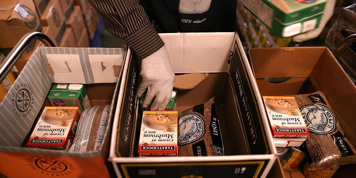 RICHMOND, CA - NOVEMBER 01:  Richmond Emergency Food Bank volunteer Abdul Olorode packs boxes with food to be handed out to needy people on November 1, 2013 in Richmond, California.  An estimated 47 million Americans will see their food stamp benefits cut starting today as temporary relief to the federal program ends with no new budget from Congress to replace it. Under the new Supplemental Nutrition and Assistance Program (SNAP), a family of four that used to receive $668 per month will see that amount cut by $36.  (Photo by Justin Sullivan/Getty Images)
