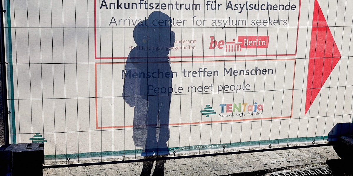 a person is standing in front of a sign