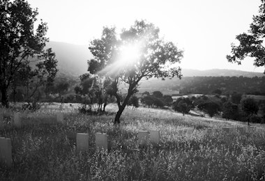 IRAQ. Barzan. July 14, 2014. The sun rises over a memorial cemetery in the village of Barzan, the hometown of Kurdish leader Masoud Barzani, where the remains of 603 Kurdish villagers, killed by Saddam Hussein forces during the late 1980's Al Anfal campaign against the Kurds, have been laid to rest.Many of the victims were sent to southern Iraq, where they were executed or buried alive in mass graves. The remains of 603 Kurdish villagers from Barzan found in mass graves in southern Iraq have been returned and laid to rest in this memorial cemetery on a hill outside the village.