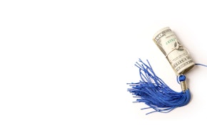 a roll of money with a blue tassel