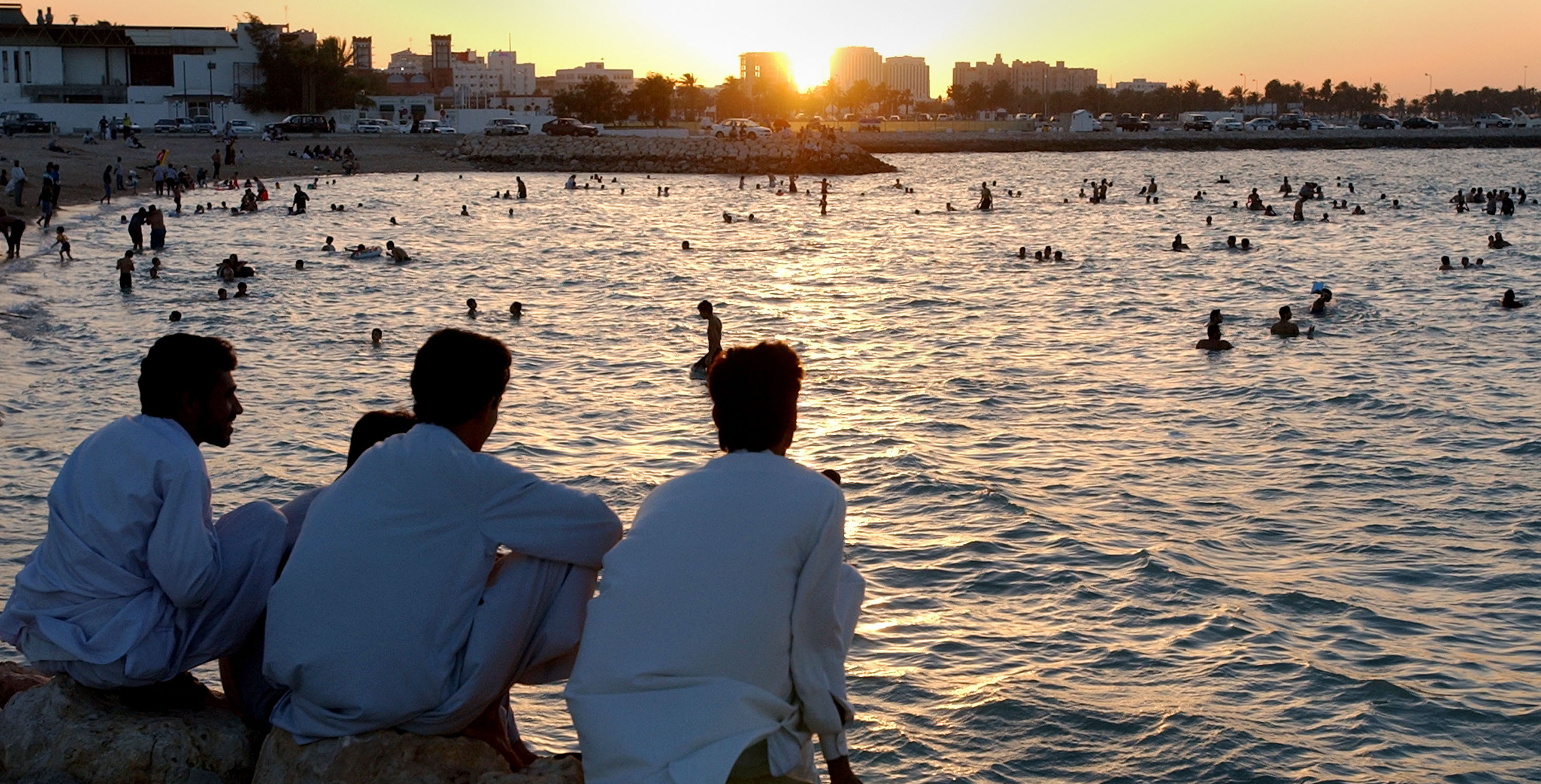 People watching the sunset along the beach.