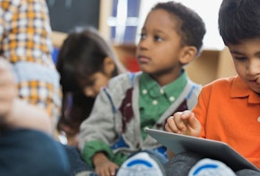 a group of young children sitting next to each other