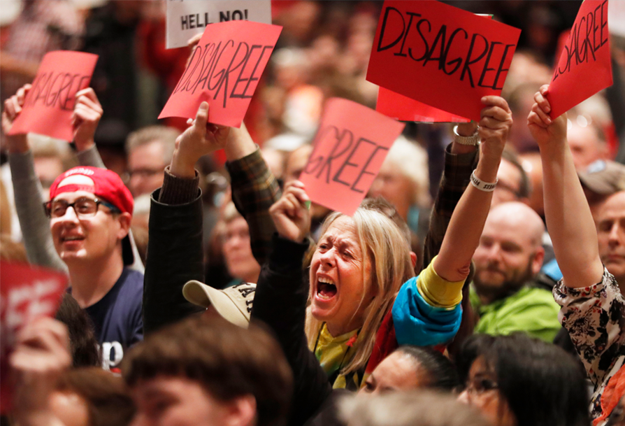 Demonstrators holding signs with the text disagree.