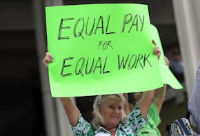 a woman holding a sign that says equal pay for equal work