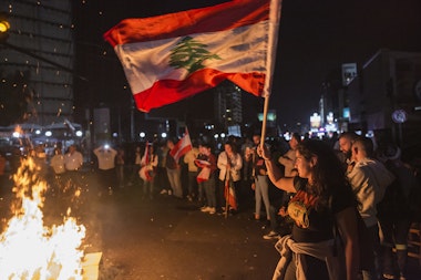 BEIRUT, LEBANON - NOVEMBER 03: A protester waves a Lebanese flag as anti-government demonstrators block the Chevrolet intersection on November 3, 2019 in Beirut, Lebanon. The country has seen 18 days of unrest after demonstrators took to the streets to protest tax hikes and government corruption. (Photo by Sam Tarling/Getty Images) (Photo by Getty Images/Getty Images)