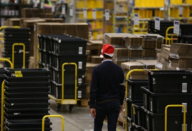 PETERBOROUGH, ENGLAND - NOVEMBER 27: (EDITORS NOTE: EMBARGOED TO 0001 ON THURSDAY NOVEMBER 28, 2019) A worker in the Peterborough Amazon Fulfilment Centre prepares for Black Friday on November 27, 2019 in Peterborough, England. The Amazon Black Friday sale runs from November 22-29, with thousands of deals on the latest consumer electronics and Amazon devices as well as this year's must-have toys, games, fashion, jewellery, beauty, home items and more. (Photo by Hollie Adams/Getty Images)