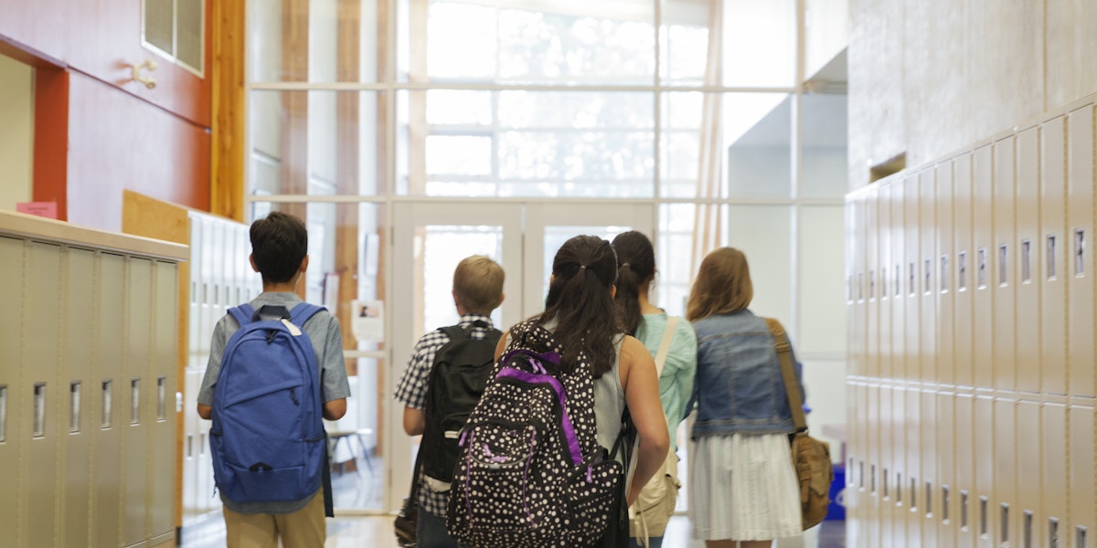Students walking through a school hallway.