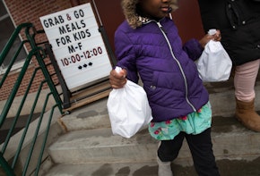 STAMFORD,  - MARCH 17: A student carries home bagged meals given out as part of Stamford Public Schools' 