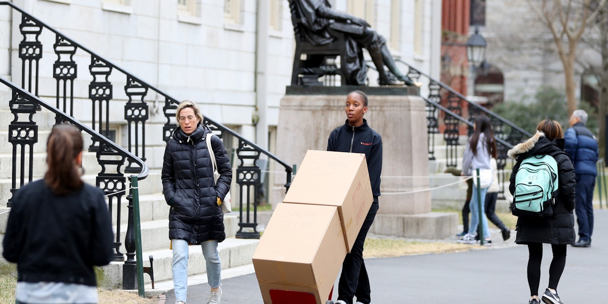 CAMBRIDGE, MASSACHUSETTS - MARCH 12: Sophomore Sadia Demby moves her belongings through Harvard Yard on the campus of Harvard University on March 12, 2020 in Cambridge, Massachusetts. Students have been asked to move out of their dorms by March 15 due to the Coronavirus (COVID-19) risk. All classes will be moved online for the rest of the spring semester.  (Photo by Maddie Meyer/Getty Images)