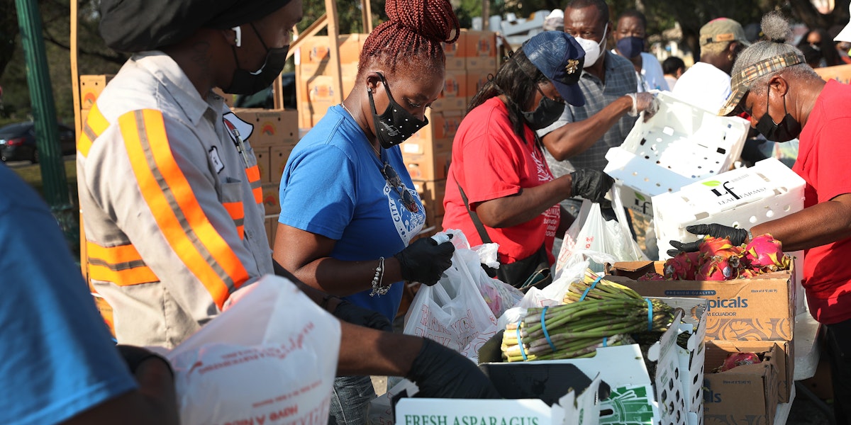 OPA LOCKA, FLORIDA - APRIL 14: City of Opa-locka employees and volunteers prepare bags of food, provided by the food bank Feeding South Florida, to be given out to the needy at a drive-thru distribution site on April 14, 2020 in Opa-locka, Florida. Feeding South Florida has seen a 600 percent increase in those asking for food aid as people, some of whom have lost jobs, need to make ends meet during the coronavirus pandemic.  (Photo by Joe Raedle/Getty Images)