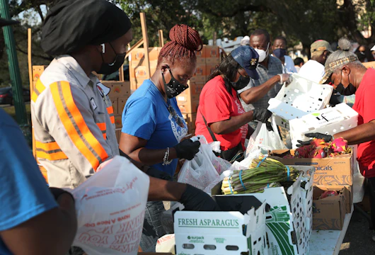 OPA LOCKA, FLORIDA - APRIL 14: City of Opa-locka employees and volunteers prepare bags of food, provided by the food bank Feeding South Florida, to be given out to the needy at a drive-thru distribution site on April 14, 2020 in Opa-locka, Florida. Feeding South Florida has seen a 600 percent increase in those asking for food aid as people, some of whom have lost jobs, need to make ends meet during the coronavirus pandemic. (Photo by Joe Raedle/Getty Images)
