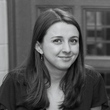 a black and white photo of a woman smiling