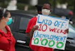 MIAMI BEACH, FLORIDA - MAY 22: Joseph Louis joins others in a protest asking the state of Florida to fix its unemployment system on May 22, 2020 in Miami Beach, Florida. Unemployed hospitality and service workers who have not received unemployment checks held the protest demanding Florida Governor Ron DeSantis fix the unemployment system and send out their benefits. Since the closure of all non-essential businesses due to the coronavirus pandemic, hundreds of thousands of hospitality workers across Florida find themselves out of work. Florida’s unemployment system has not worked reliably. (Photo by Joe Raedle/Getty Images)