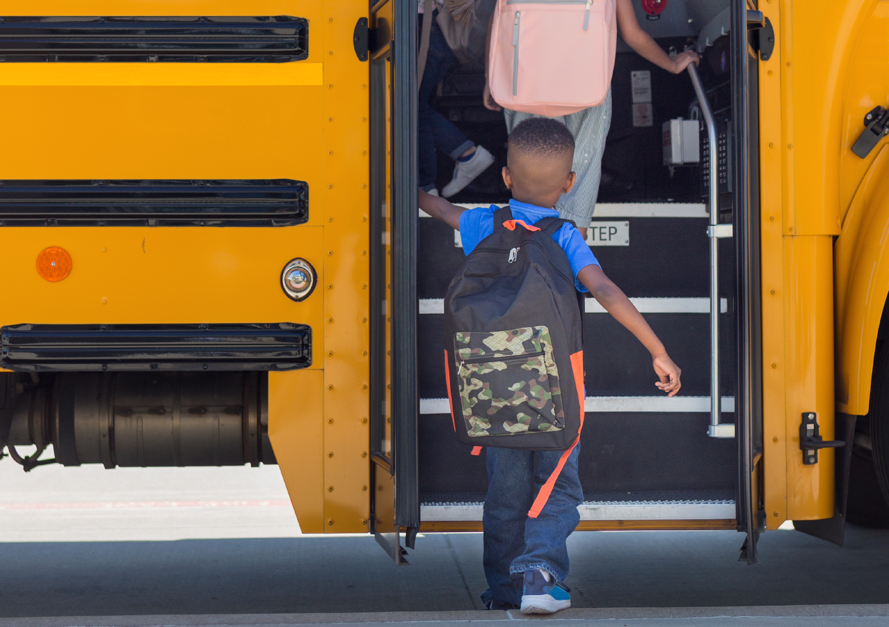 A child entering a school bus