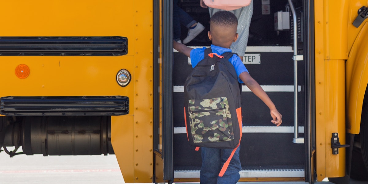 A child entering a school bus