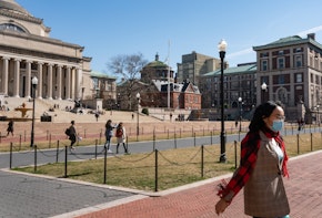 NEW YORK, NY - MARCH 09: A woman wearing a protective mask walks on the Columbia University campus on March 9, 2020 in New York City. The university is canceling classes for two days after a faculty member was quarantined for exposure to the novel coronavirus. The remainder of the week would be taught remotely. (Photo by Jeenah Moon/Getty Images)
