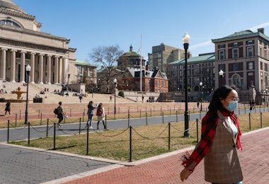 NEW YORK, NY - MARCH 09: A woman wearing a protective mask walks on the Columbia University campus on March 9, 2020 in New York City. The university is canceling classes for two days after a faculty member was quarantined for exposure to the novel coronavirus. The remainder of the week would be taught remotely. (Photo by Jeenah Moon/Getty Images)