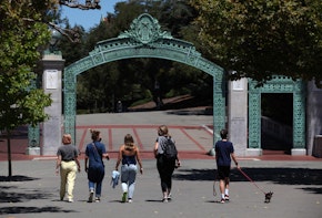 BERKELEY, CALIFORNIA - JULY 22: People walk towards Sather Gate on the U.C. Berkeley campus on July 22, 2020 in Berkeley, California. U.C. Berkeley announced plans on Tuesday to move to online education for the start of the school's fall semester due to the coronavirus COVID-19 pandemic. (Photo by Justin Sullivan/Getty Images)