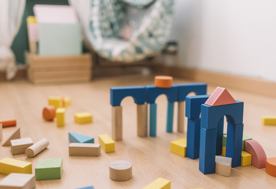 colorful wooden building blocks in the floor at home or kindergarten, educational toys for creative children